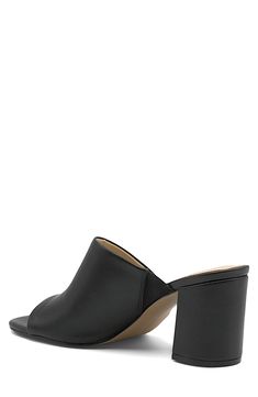 An asymmetrical strap creates a unique touch on this classic open toe mule. 3.5" heel Open toe Asymmetrical vamp Slip-on Block heel Manmade upper, lining, and sole Imported