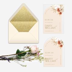 an envelope, card and flower are shown with the wedding stationery in gold glitter