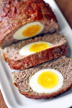 meatloaf with two eggs on top is sitting on a white plate