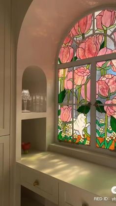 an arched window with pink flowers on it