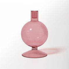 a pink vase sitting on top of a white table