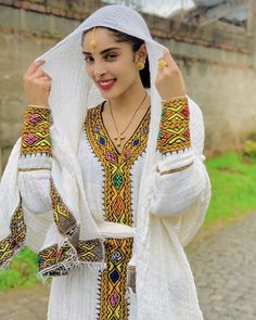 Traditional Tunic Dresses For Festivals, Traditional Tunic Dress With Embroidered Border, Traditional Embroidered Abaya, Fitted Habesha Kemis For Eid, Bohemian Style Long Sleeve Habesha Kemis For Weddings, Bohemian Long Sleeve Habesha Kemis For Wedding, Traditional Long Sleeve Habesha Kemis, Traditional Long Sleeve Habesha Kemis For Festivals, Ceremonial Long Sleeve Habesha Kemis For Eid