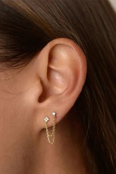 A woman wearing a double stud chain earring. Double Piercing Earrings Quality, Earrings For Two Piercings Dainty, Cheap Small Hoop Piercings For Pierced Ears, Small Earring Chain, Earrings 2 Holes Hoops, Earrings 2 Holesstud, Cheap Trendy Single Earring Piercing, Cheap Pierced Earrings For Summer, Silver Earrings Two Holes Stud