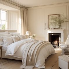 a bedroom with a bed, chair and fire place in it next to a window