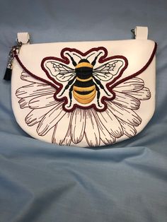 This beautifully embroidered, fully lined crossbody bag with a zipper closure and generous  back pocket. The color/pattern of vegan leather (PU vinyl) and embroidery thread can be customized for no additional costs.  Bee lovers love this bag! The bag and embroidery pattern is from Emfreudery Designs Everyday Leather Shoulder Bag With Embroidered Logo, Leather Shoulder Bag With Embroidered Logo For Everyday Use, Travel Crossbody Shoulder Bag With Embroidered Logo, Sling Bags, Phone Purse, Embroidery Pattern, Honey Bee, Embroidery Thread, Cross Body Handbags