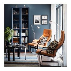 a living room filled with furniture and bookshelves next to a large blue book case