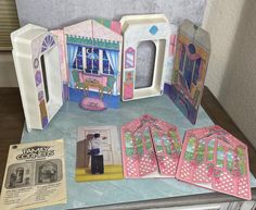 an assortment of dollhouse furniture and accessories on a table