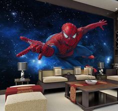 a living room filled with furniture and a spider man mural on the wall above it