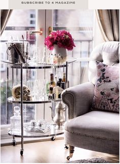 a chair sitting in front of a window filled with bottles and glasses