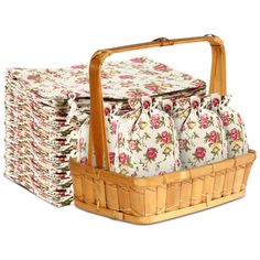 a basket filled with lots of cloths next to a stack of folded towels on top of each other