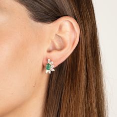 Our Helen earrings combine the timeless elegance of emeralds and diamonds in a contemporary design. Made with high quality cz diamonds and crystal emeralds set in gold plated sterling silver. Custom backs ensure the earrings sit perfectly on the ear. .6" L x .4" W Pierced. Stud style earrings Please contact us to special order larger quantities. Small Emerald Earrings, Green Diamond Earrings For Evening, Green Diamond Drop Earrings With Accents, Luxury Green Diamond Earrings With Accents, Green Pave Setting Earrings For Wedding, Formal Green Diamond Cluster Earrings, Elegant Green Emerald Cut Diamond Earrings, Green Earrings With Diamond Accents For Party, Green Cubic Zirconia Diamond Drop Earrings