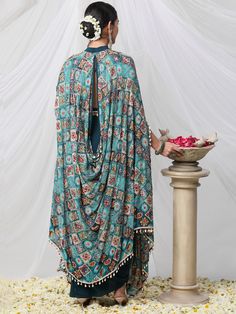 Peacock blue Coloured Cape dress with Tube and Drape Skirt and Zari work cape. Pure crepe 3(Tube, skirt, Cape) Cape Dress Feel regal and extraordinary in this ornate classic piece of art. Perfect for special occasions or just for everyday indulgence. Its intricate design, luxurious fabric, and intricate embroidery make this a timelessly elegant garment that will stand out in any wardrobe. Enjoy the feeling of luxury and unparalleled quality with this exquisite ensemble. Skirt Cape, Upcycled Tote, Tube Skirt, Pop Up Event, Zari Work, Cape Dress, Intricate Embroidery, Peacock Blue, Intricate Design