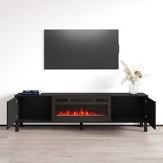 an entertainment center with a fire place and television on it's stand in front of a white wall