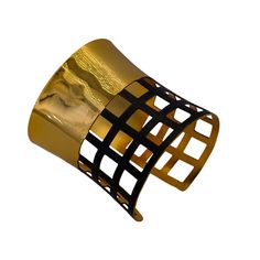 In this design, we've crafted a striking wide-cuffed bracelet adorned with geometric cubes to exude simplicity, style, and harmony. The bracelet features a prominent cuff design with geometric embellishments, creating a captivating dual-tone aesthetic for a seamless look. Crafted with brass as the primary metal, it's plated with 24-karat pure gold and coated with black rhodium for both durability and luxurious appeal. Here are the detailed specifications: Material: Brass main metal plated with 24-karat pure gold Design: Wide cuff adorned with geometric cubes Flexibility: Flexible for comfortable wear Measurements: Bracelet width: 2.76 inches Bracelet length: 6.42 inches This description highlights the intricate craftsmanship and use of premium materials, elevating any outfit with a touch o Adjustable Cuff Bracelet For Party, Unique Formal Cuff Bracelet Bangle, Unique Formal Cuff Bracelet, Luxury Metal Bangle Bracelet, Luxury Adjustable Cuff Bangle, Luxury Jubilee Cuff Bracelet As Gift, Handmade Modern Party Bangle, Luxury Adjustable Jubilee Cuff Bracelet, Modern Handmade Party Bangle