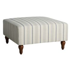 a striped foot stool with wooden legs