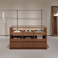 a wooden cabinet with drawers in front of a mirror