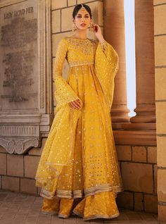 Safeeneh Semi-stitched Yellow Palazzo Set In Chanderi, Yellow Anarkali Palazzo Set For Eid, Eid Anarkali Sharara With Mirror Work, Anarkali Sharara With Dabka Work For Festivals, Yellow Palazzo Set With Dupatta For Diwali, Yellow Palazzo Set With Zari Work For Eid, Diwali Yellow Palazzo Set With Dupatta, Traditional Yellow Palazzo Set For Eid, Eid Sharara With Mirror Work In Chinon