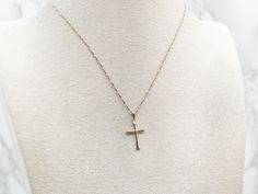 This classic yellow gold pendant is delicate and dainty, perfect for adding a sweet, subtle touch of faith to your look. Whether you choose to accessorize for a special occasion or just to bring a little joy to a regular day, this delightful cross will brighten up any ensemble!This pendant does not come with the chain shown. Don't hesitate to get in touch with us, we will help you find the perfect chain for your style and budget!Metal: 14K Yellow GoldMeasurements: 14 x 26 mm, with bailMarks: "14K USA" Stamped on the reverse 14k Gold Cross Necklace With Delicate Chain, Minimalist Cross Pendant Necklace For First Communion, Minimalist Cross Jewelry For First Communion, Delicate Everyday Cross Necklace, 14k Yellow Gold Filled Cross Necklace, Simple Yellow Gold Cross Necklace, Delicate Everyday Cross Pendant Jewelry, Delicate Cross Jewelry With Delicate Chain, Dainty Cross Jewelry With Delicate Chain