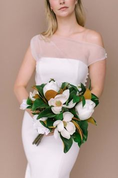 a woman in a white dress holding a bouquet