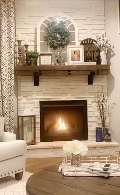 a living room filled with furniture and a fire place in the middle of the room