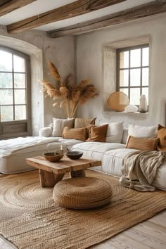 a living room filled with furniture and large windows