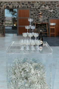 several wine glasses are stacked on top of each other in front of a display case