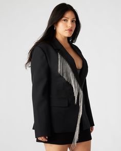 The NELLIE blazer is a stunning, single-breasted blazer that features rhinestone fringe detailing and functional flap pockets. Designed with a back vent and faux chest welt pockets, this blazer offers a touch of glamour and sophistication to any outfit. Perfect for work or special occasions. Rhinestone fringe blazer Single-breasted Two functional front pockets Length: 28.5" 97% polyester 3% elastane Hand wash Amelia is 5ft 10.5in and is wearing a size small Vanessa is 5ft 8in and is wearing a si Embellished Blazer With Notch Lapel For Work, Embellished Notch Lapel Blazer For Work, Glamorous Notch Lapel Blazer For Workwear, Glamorous Tailored Blazer For Workwear, Fall Embellished Outerwear With Notch Lapel, Glamorous Tailored Outerwear With Notch Lapel, Glamorous Tailored Blazer For Fall, Glamorous Tailored Fall Blazer, Glamorous Fall Office Blazer