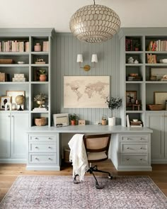 a home office with built - in bookcases, desk and rug on the floor