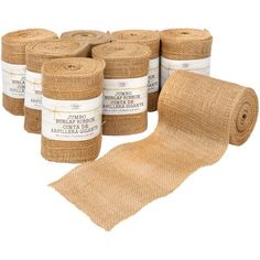 several rolls of jute burlock with labels on each roll and one roll is rolled up