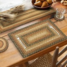 the table is set with placemats and bowls of apples