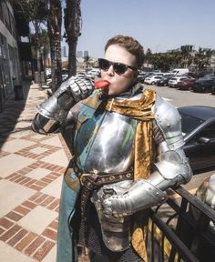 a man dressed in armor drinking from a straw