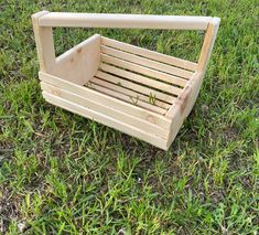 a wooden crate sitting on top of a lush green field