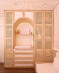 a baby's room with pink and white decor