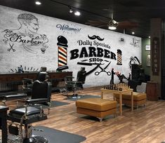 a barber shop with chairs and signs on the wall