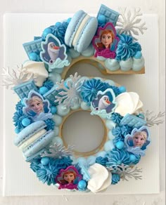 a frozen princess birthday cake with frosting and decorations