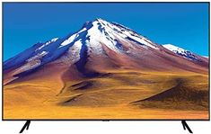 an image of a mountain with snow on it's top and blue sky in the background