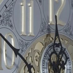 a close up of a clock face with numbers and symbols on the dials,