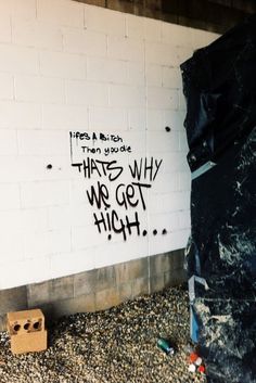 graffiti on the side of a building that says what's why we get high