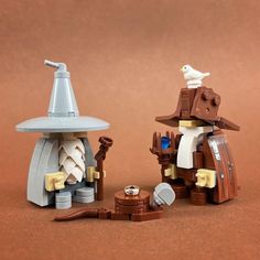 two lego figurines, one with a hat and the other holding a bird