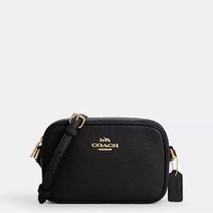 This Coach Mini Jamie Signature Canvas Camera Bag In Black Is A Stylish And Functional Accessory For Any Woman. With A Zip Closure, Shoulder Strap, And Adjustable Strap Drop Of 22.75 Inches, This Crossbody Bag Is Perfect For Casual Or Workwear Occasions. The Bag Measures 2.25 Inches In Width, 5.25 Inches In Height, And 7.5 Inches In Depth, Making It A Compact Yet Practical Size. The Bag Features A Unique Combination Of Canvas And Leather Exterior Materials, With Brown Hardware Accents. The Inter Mini Camera, Coach Outlet, Bags Coach, Bag Coach, Signature Canvas, Functional Accessories, My Wish List, Leather Fabric, Pebbled Leather