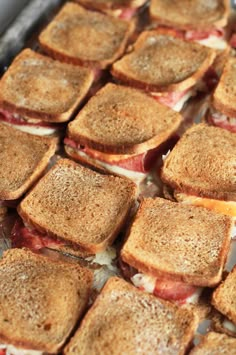 toasted sandwiches sitting on top of a pan