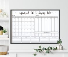 a printable calendar hangs on the wall next to a potted plant and bookshelf