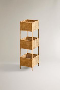 a wicker shelf with three baskets on it