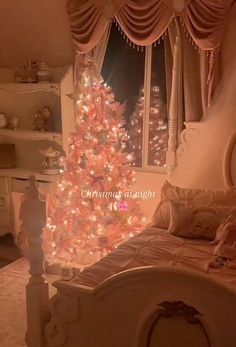 a bedroom decorated for christmas with a pink tree