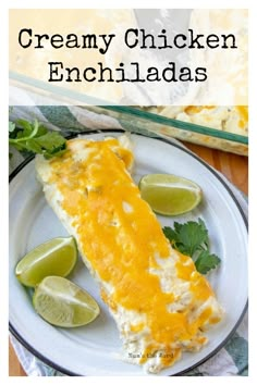 a white plate topped with an enchilada covered in cheese and cilantro