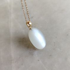 This stunning Pendant is set in 14k Solid Yellow Gold with Natural White moonstone drilled with utmost precision. It is a unique gemstone Pendant for nearly every occasion and is completely hassle-free jewelry. ITEM DETAILS: * GEM: White moonstone * GEM SIZE: 16X24mm * GEM SHAPE: Oval * Gem weight: 24.82 carats * Gold Purity: 14KT * Gold Weight: 0.42 gram * Total Weight of the Pendant: 5.39 gram The Gold purity is guaranteed and it comes with authentic 14KT gold hallmark. Since my items are hand White Oval Necklace With Polished Finish, White Oval Pendant With Polished Finish, White Oval Pearl Pendant Jewelry, White Polished Moonstone Ring, Delicate White Moonstone Gemstone Ring, White Moonstone Cabochon Jewelry, White Cabochon Moonstone Jewelry, Delicate White Moonstone Ring, Elegant White Teardrop Moonstone Ring