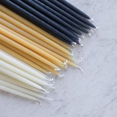 several different colored straws lined up on a marble surface