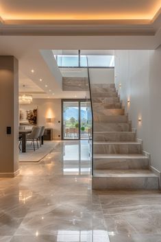 an open floor plan with stairs leading up to the dining room