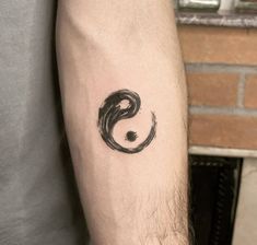 a man's arm with a tattoo on it that has the letter s in black ink