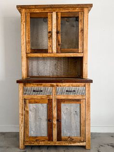 an old wooden cabinet with glass doors